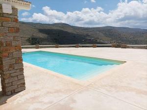 a swimming pool on top of a house at Koundouros Petra house in Koundouros