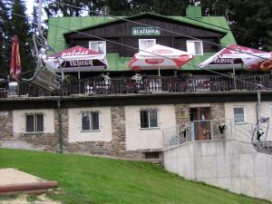 a building with umbrellas on top of it at Ski & Bike Špičák in Železná Ruda