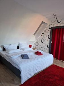 a bedroom with a bed with two towels on it at Hexenhaus in Lüneburg