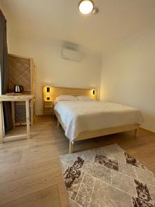 a bedroom with a large bed and a rug at Dalaman Airport AliBaba Hotel in Dalaman