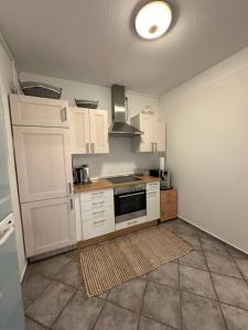 a kitchen with white cabinets and a stove top oven at ELMIRA in Memmingen