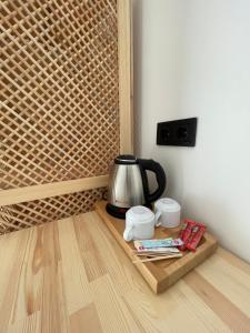 a tea kettle on a wooden tray on the floor at Dalaman Airport AliBaba Hotel in Dalaman