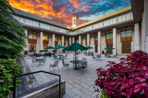 a courtyard with tables and chairs with a sunset at The Charles F. Knight Center in University City