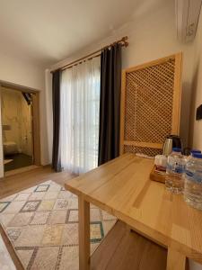 a room with a wooden table and a window at Dalaman Airport AliBaba Hotel in Dalaman