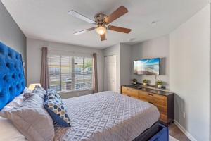 a bedroom with a bed and a ceiling fan at Mickey's Magical Townhome Venetian Bay Villages in Kissimmee