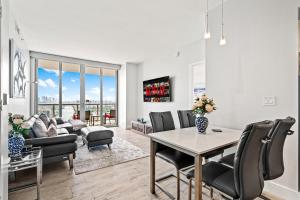 a living room with a table and chairs at Ocean Views - Pool & Gym - Pet Friendly - Close to Beach in Hallandale Beach