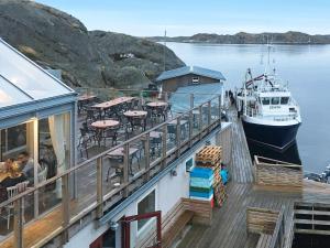 a boat is docked at a dock with a restaurant at Holiday home Nösund VI in Nösund