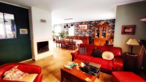 un soggiorno con un divano rosso e un tavolo di Maison de famille a Benet