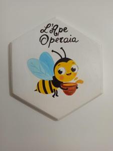 a sign with a bee holding a basket at B&BEES in Rocca Ranieri
