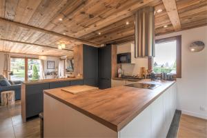 a kitchen with a large counter top in a room at Magnificent chalet with view in Praz-sur-Arly - Welkeys in Praz-sur-Arly