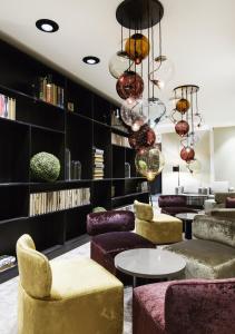 a lobby with purple and yellow chairs and tables at Quality Hotel Grand Kristiansund in Kristiansund