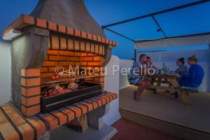 a rendering of a pizza oven with people sitting at a table at Ferienwohnung in Son Baulo mit Grill in Can Picafort