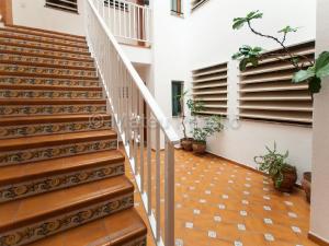 a staircase in a house with potted plants at Ferienwohnung in Son Baulo mit Grill in Can Picafort +12 photos