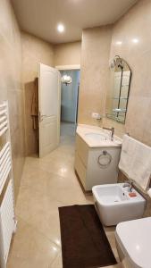 a bathroom with a sink and a toilet and a mirror at Alba's House Lura1 Residence in Draç +7 photos