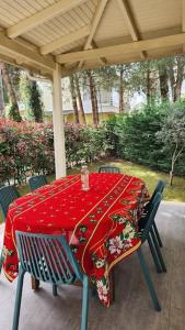 a table with a red table cloth on a patio at Alba's House Lura1 Residence in Draç