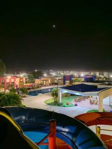 a view of a pool at a resort at night at Cozy family home in private condo in Santa Cruz de la Sierra