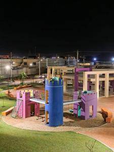 a playground in front of a building at night at Cozy family home in private condo in Santa Cruz de la Sierra