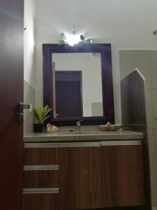 a bathroom with a sink and a mirror at Cozy family home in private condo in Santa Cruz de la Sierra