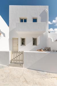 una casa con pareti bianche e una scala di ELAIA HOME a Galini