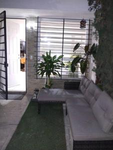 a living room with a couch in front of a door at Casa Orquídea in Guadalajara