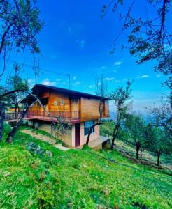 a house on the side of a hill at Praveen Woodhouse and Homestay Kodaikanal Vattakanal in Kodaikānāl