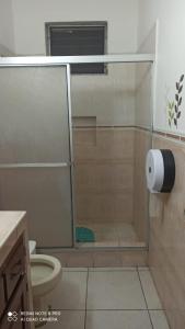 a shower with a glass door in a bathroom at LA CASA DE DON MATILDE in San Pedro Sula