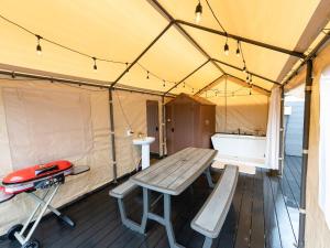 a tent with a wooden table and benches in it at ＳＰＲＩＮＧＳ ＶＩＬＬＡＧＥ - Vacation STAY 67329v in Oyama