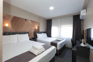 Postel nebo postele na pokoji v ubytování BURSA LOYAL CiTY HOTEL