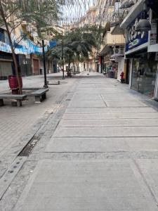 an empty city street with benches and buildings at Cairo Casa Hotel in Cairo
