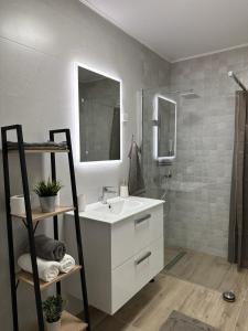 a white bathroom with a sink and a shower at Apartman ZEN in Popovača +32 photos