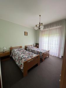 een slaapkamer met 2 bedden en een raam bij Casa46 in Costa Volpino