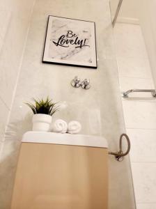 a bathroom with a sink and a picture on the wall at Apartment mit Rheinblick Koblenz in Koblenz +10 photos