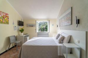 a bedroom with a large bed and a window at B&B Vignola in Levanto