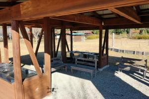 a wooden pavilion with benches in a field at Toso Youth Travel Village - Vacation STAY 30509v 