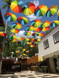 a bunch of colorful umbrellas flying in the air at Hotel las marias de neiba in Cerro en Medio