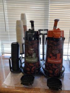a couple of coffee makers sitting on top of a table at Super 8 by Wyndham Williams West Route 66 - Grand Canyon Area in Williams