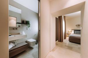 uma casa de banho com um lavatório, um WC e um espelho. em Le Contrade Di San Salvatore em Monopoli