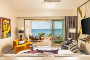 a living room with a view of the ocean at Hotel Mousai Cancun Adults Only - All Inclusive in Cancún