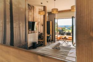 a mirror in a room with a view of a living room at Sztygarka Hetmańska Resort Solina in Solina