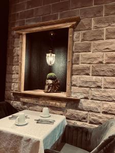 a table in a restaurant with a brick wall at Le Château du Landsberg in Barr +30 photos