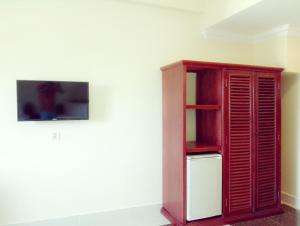 a wooden cabinet sitting next to a wall at Golden Star Inn in Sihanoukville