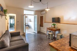 a living room with a couch and a table at Casa San Lorenzo - Mercato Centrale in Florence