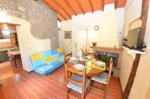 a living room with a table and a dining room at Ferienhaus mit Privatpool für 4 Personen ca 50 qm in Loppeglia, Toskana Provinz Lucca in Loppeglia