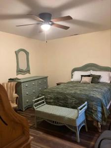 a bedroom with a bed and a ceiling fan at Whiteshomesplus in Joplin