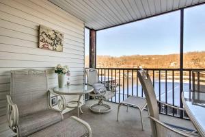 a patio with a table and chairs on a balcony at Waterfront Condo with Boat Slip! in Lake Ozark