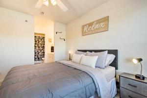 a bedroom with a large bed and a sign on the wall at Waterfront Condo with Boat Slip! in Lake Ozark +18 photos