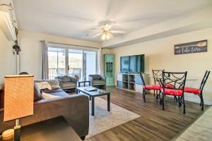 a living room with a couch and chairs and a table at Waterfront Condo with Boat Slip! in Lake Ozark