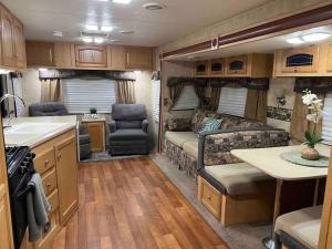 a kitchen and living room of an rv at WARM AND COZY RV 3 in Miami