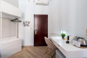 a kitchen with a white counter and a brown door at ESQUILINO HARMONY GUESTHOUSE - close to COLOSSEUM in Rome