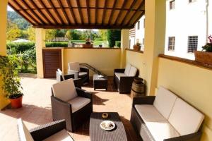 een patio met banken en stoelen en een tafel bij Ferienwohnung für 6 Personen ca 78 qm in Monsagrati, Toskana Provinz Lucca in Monsagrati